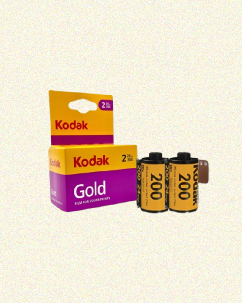 Kodak Gold 200 film packaging with two film cans on a beige background