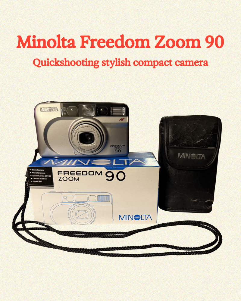 Minolta Freedom Zoom 90 camera with packaging and case on a beige background
